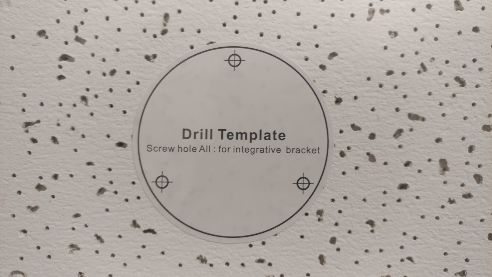 place drill template on ceiling tile